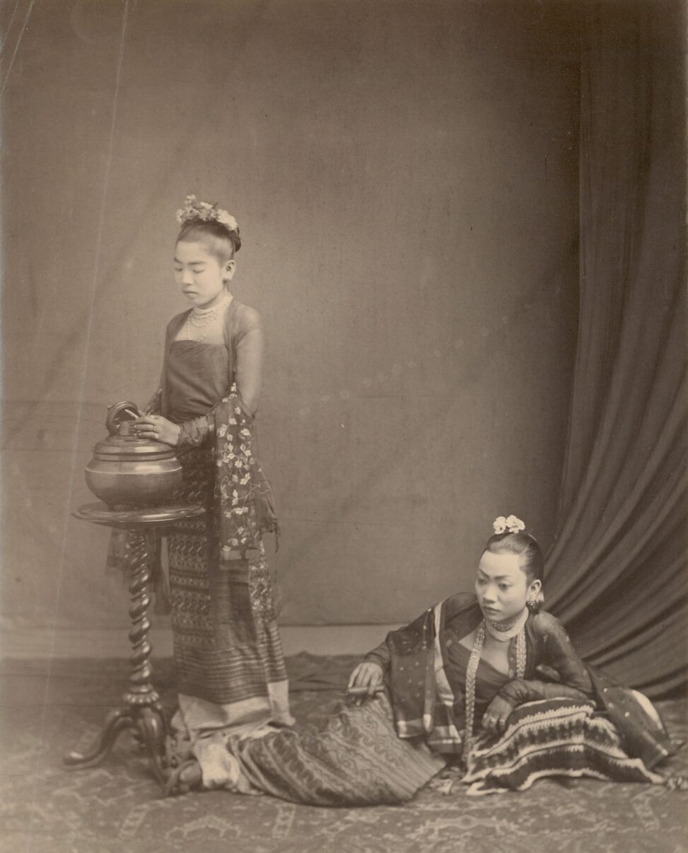 Two women in Burma that are posed in a picture
